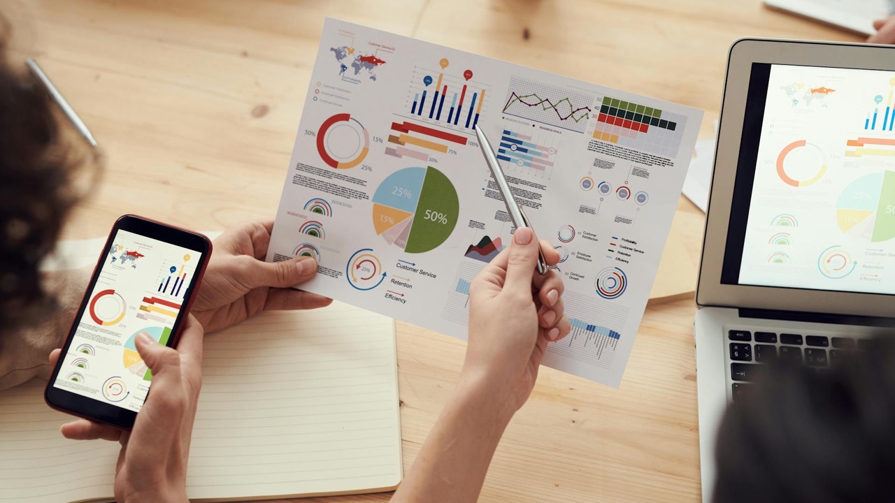 Business analytics dashboards and data visualizations across multiple devices representing workflow automation